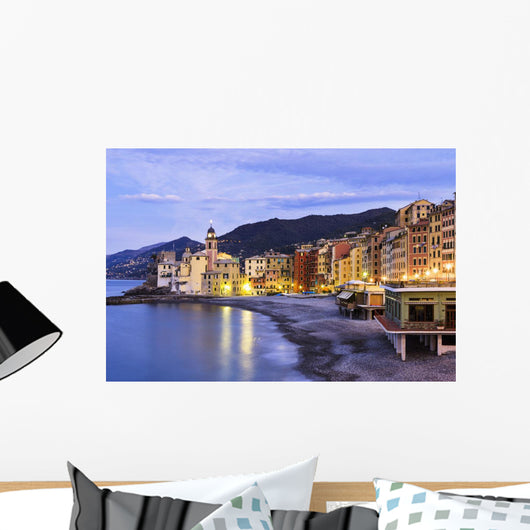 Buildings illuminated by lights along the water's edge at sunrise Wall Mural