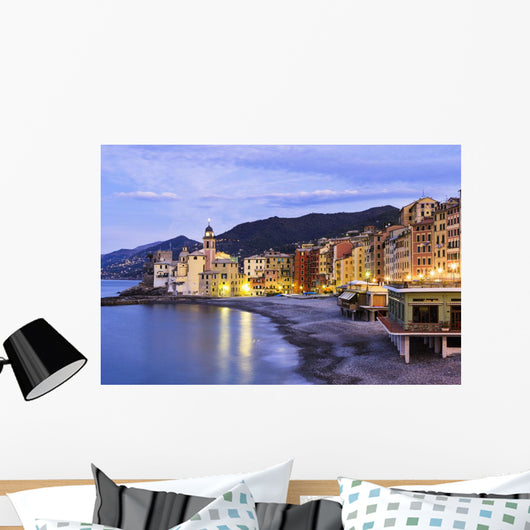 Buildings illuminated by lights along the water's edge at sunrise Wall Mural