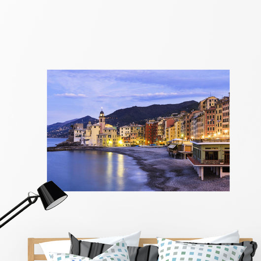Buildings illuminated by lights along the water's edge at sunrise Wall Mural