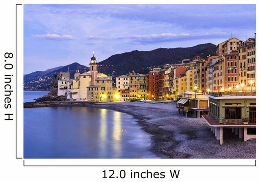 Buildings illuminated by lights along the water's edge at sunrise Wall Mural