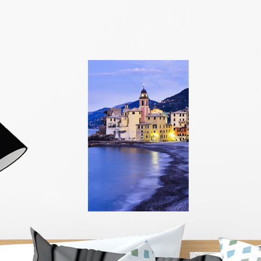 Buildings illuminated by lights along the water's edge at sunrise Wall Mural