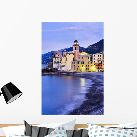 Buildings illuminated by lights along the water's edge at sunrise Wall Mural