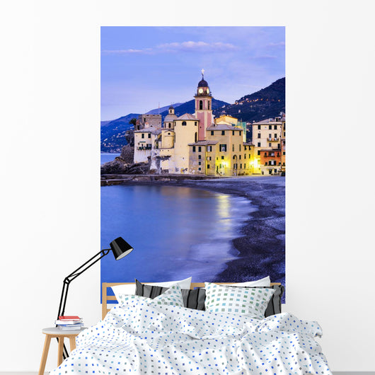 Buildings illuminated by lights along the water's edge at sunrise Wall Mural