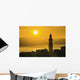 Golden sky at dusk with tower of church Wall Mural