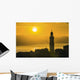 Golden sky at dusk with tower of church Wall Mural