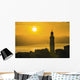Golden sky at dusk with tower of church Wall Mural