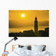 Golden sky at dusk with tower of church Wall Mural