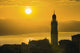 Golden sky at dusk with tower of church Wall Mural