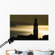 Golden sunlight reflected on water at dusk with tower of church Wall Mural