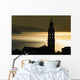 Golden sunlight reflected on water at dusk with tower of church Wall Mural