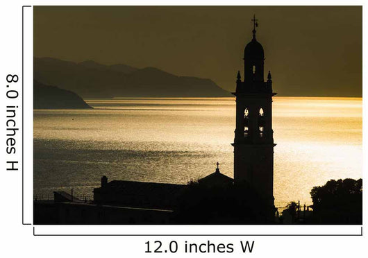 Golden sunlight reflected on water at dusk with tower of church Wall Mural