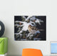 A female Common Redpoll perches on a snowy spruce tree on a cold day Wall Mural