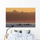 Two female sea kayakers enjoy a warm summer evening while paddling Wall Mural