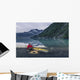 Man reading on a electronic tablet while camping with a kayak Wall Mural