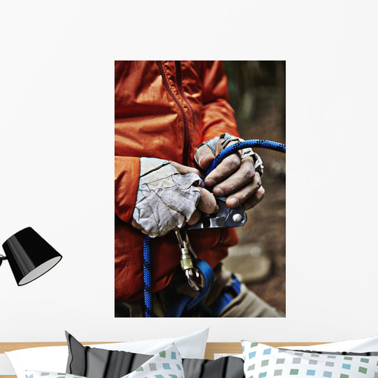 Man adjusting rock climbing equipment in the Adirondacks Wall Mural