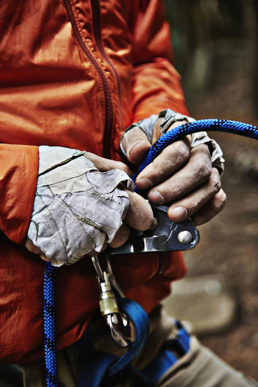 Man adjusting rock climbing equipment in the Adirondacks Wall Mural