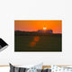 The sun sets behind a large commercial grain storage facility Wall Mural