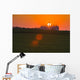 The sun sets behind a large commercial grain storage facility Wall Mural