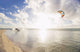 Kiteboarding in tropical lagoon in the South Pacific at sunset Wall Mural