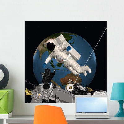 Astronaut Outer Space Wall Mural shown on a wall