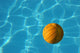 Yellow Waterpolo Ball in Blue Pool Wall Mural