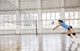 girls playing volleyball indoor game Wall Mural