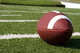 Closeup of American Football on Field Wall Mural