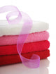 Stack of clean towels and pink ribbon Wall Mural