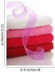 Stack of clean towels and pink ribbon Wall Mural