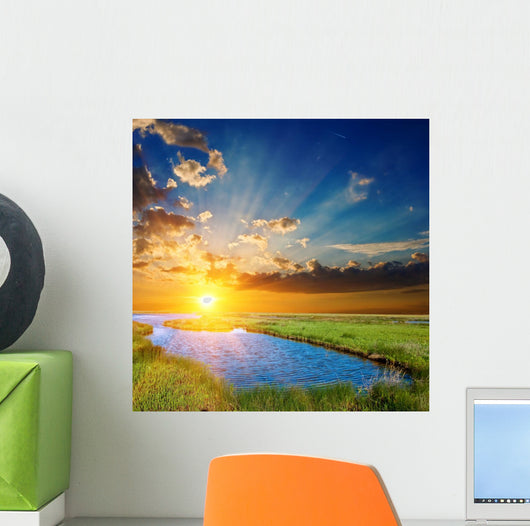 sunset over an green steppe and blue lake Wall Mural
