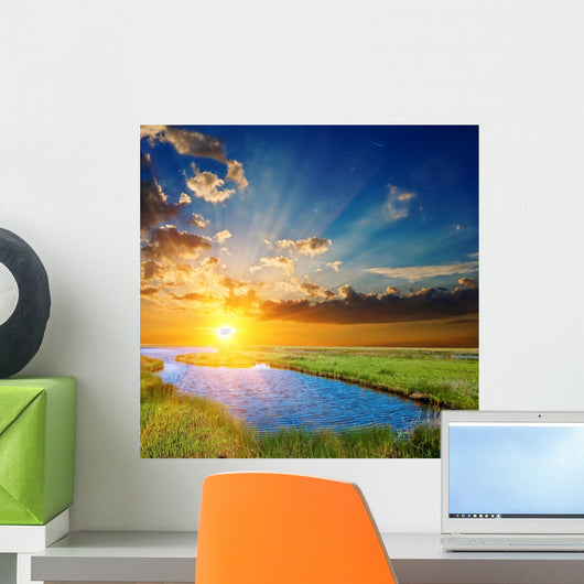 sunset over an green steppe and blue lake Wall Mural