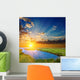 sunset over an green steppe and blue lake Wall Mural