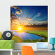 sunset over an green steppe and blue lake Wall Mural