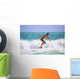 Teenage Girl in a Yellow Bikini Surfing Wall Mural