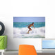 Teenage Girl in a Yellow Bikini Surfing Wall Mural