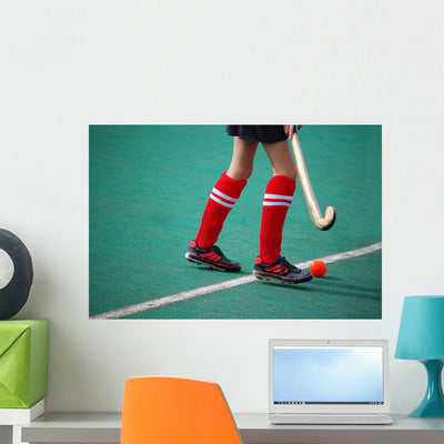 Field Hockey Girl with Wall Mural shown on a wall