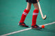 Field hockey girl with stick in hands Wall Mural