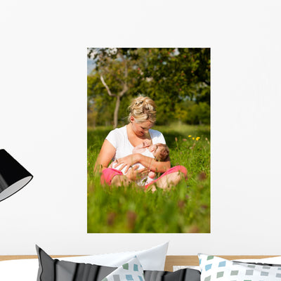 Mother Nursing Baby Meadow Wall Mural shown on a wall