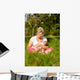 Mother nursing baby on meadow Wall Mural