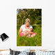 Mother nursing baby on meadow Wall Mural