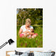 Mother nursing baby on meadow Wall Mural