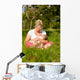 Mother nursing baby on meadow Wall Mural