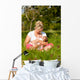 Mother nursing baby on meadow Wall Mural
