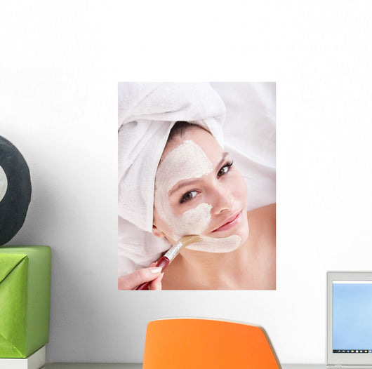 Girl with clay facial mask. Wall Mural