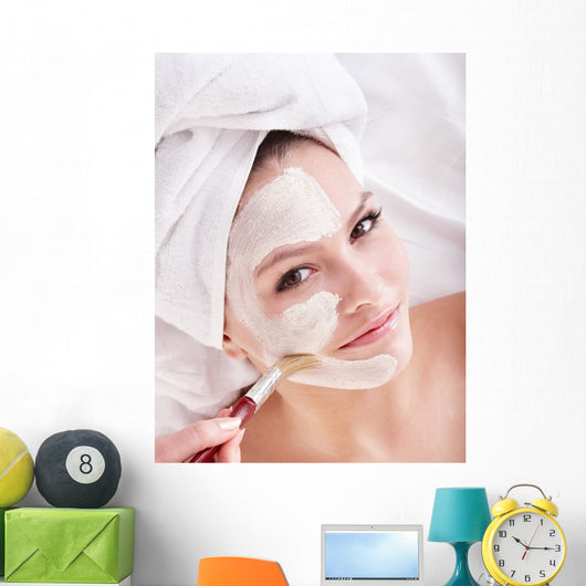 Girl with clay facial mask. Wall Mural