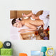 Young woman on massage table in beauty spa. Wall Mural