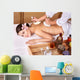 Young woman on massage table in beauty spa. Wall Mural