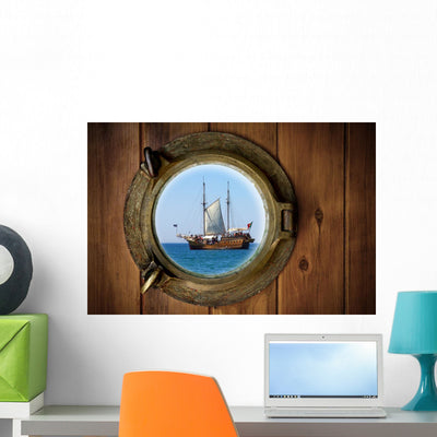 Brass Porthole Wall Mural shown on a wall