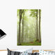 Enchanted forest with mist moving between the trees Wall Mural