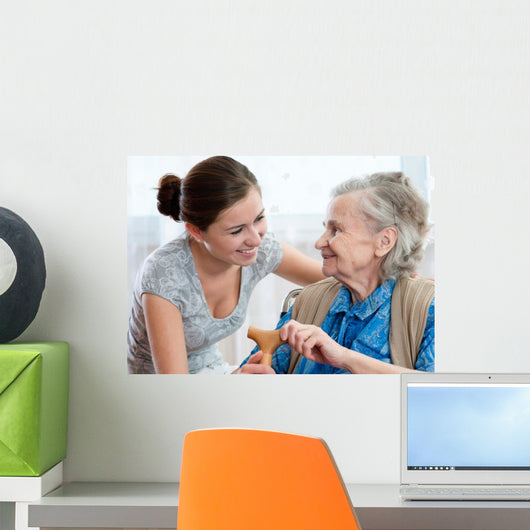 Senior woman with her home caregiver Wall Mural